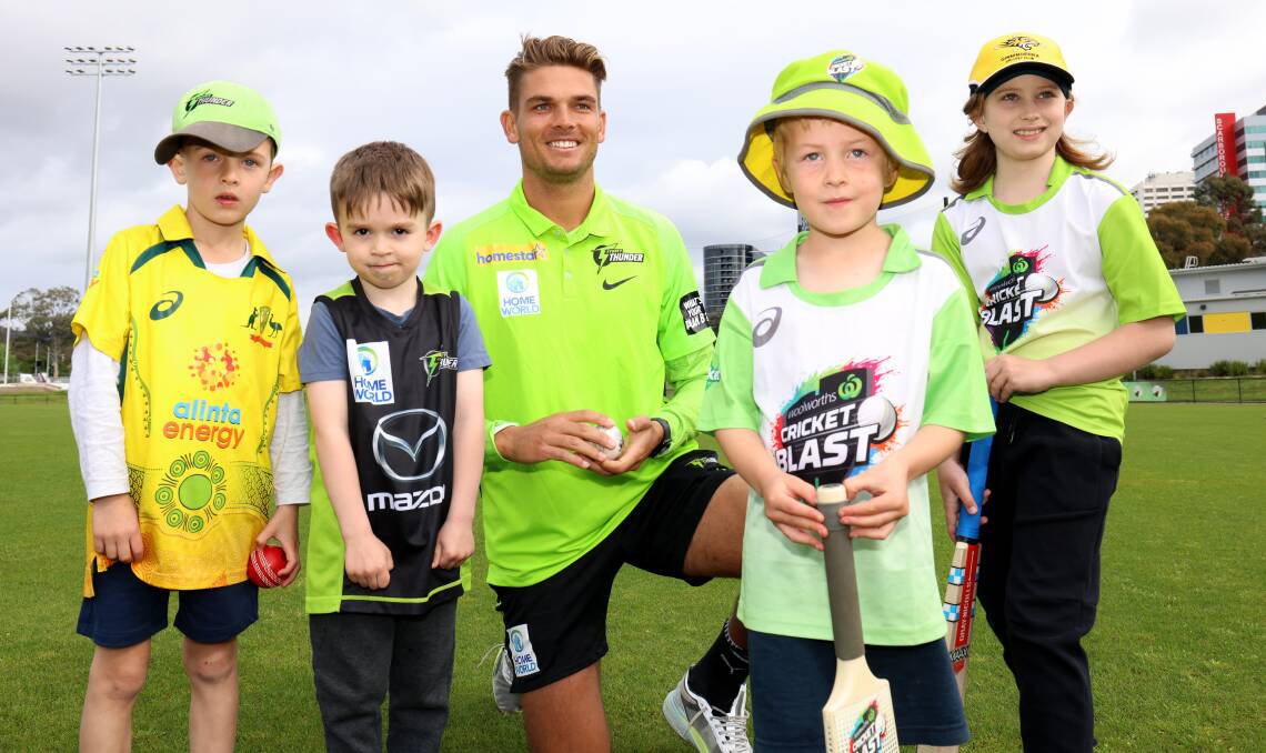 Sydney Thunder's Chris Green with junior Canberra cricketers Henry Hopewell, Jayden Stephenson, James Murphy and Fox Manley at Phillip Oval on Monday. Picture by James Croucher