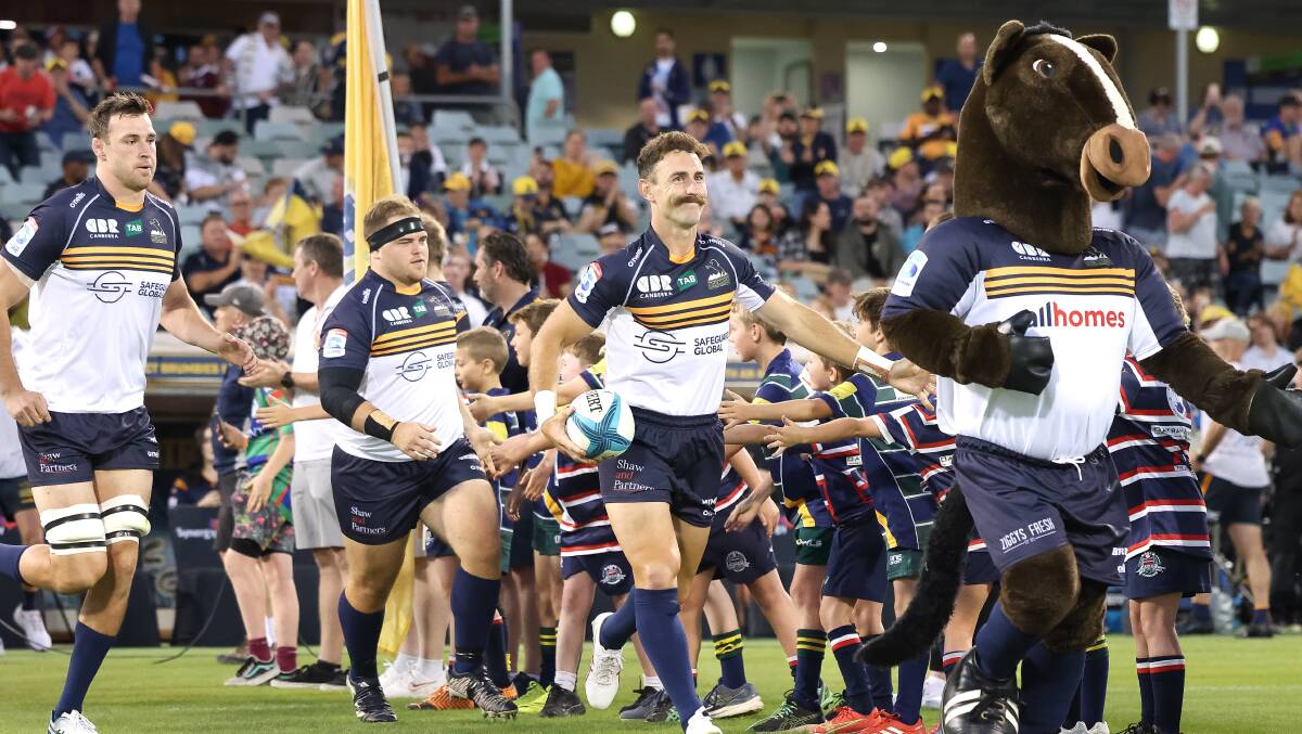 Brumbies skipper Nic White leads the team on to the field on Saturday night. Picture by Sitthixay Ditthavong