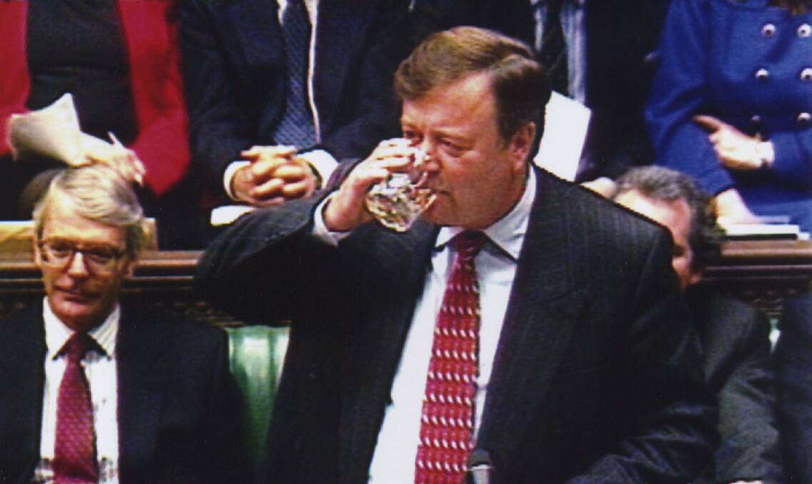 Former British Chancellor of the Exchequer Kenneth Clarke drinking scotch during his 1995 budget speech.