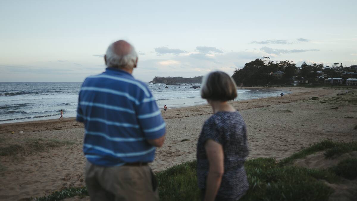 Philip Bull and Susan Magnay look out on a very different scene at Malua Bay beach compared with when they evacuated there with more than 1000 others. Picture: Dion Georgopoulos
