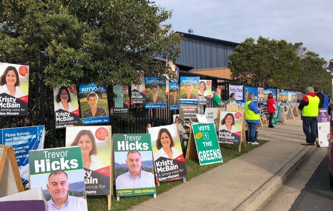 The placards and party volunteers were there, but for the most part voters stayed away from the ballot at Merimbula Public School. Picture: Elliot Williams