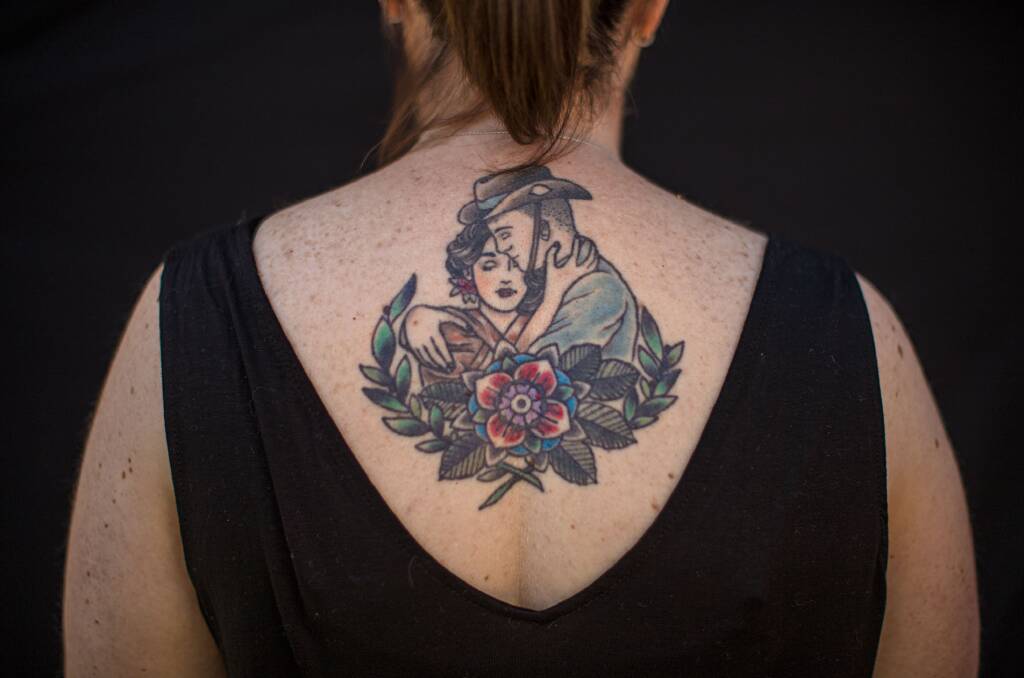 Christine Hall had an image of a woman embracing an Australia soldier tattooed on her back as a permanent reminder of her husband's homecoming.