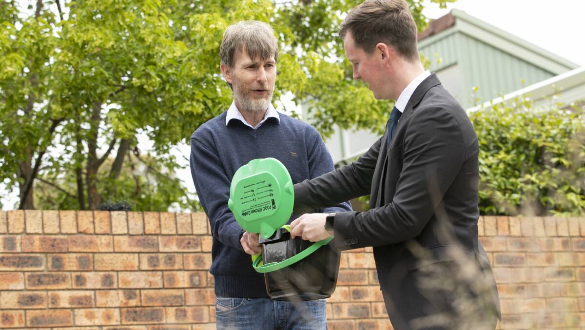 Home owner Clinton Cashen and Minister for Transport and City Services, Chris Steel at the launch of the garden organics bin trial. Picture: Keegan Carroll.
