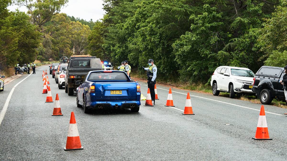 ACT police operating the border checkpoint on Sutton Road on Monday.
Picture: Matt Loxton