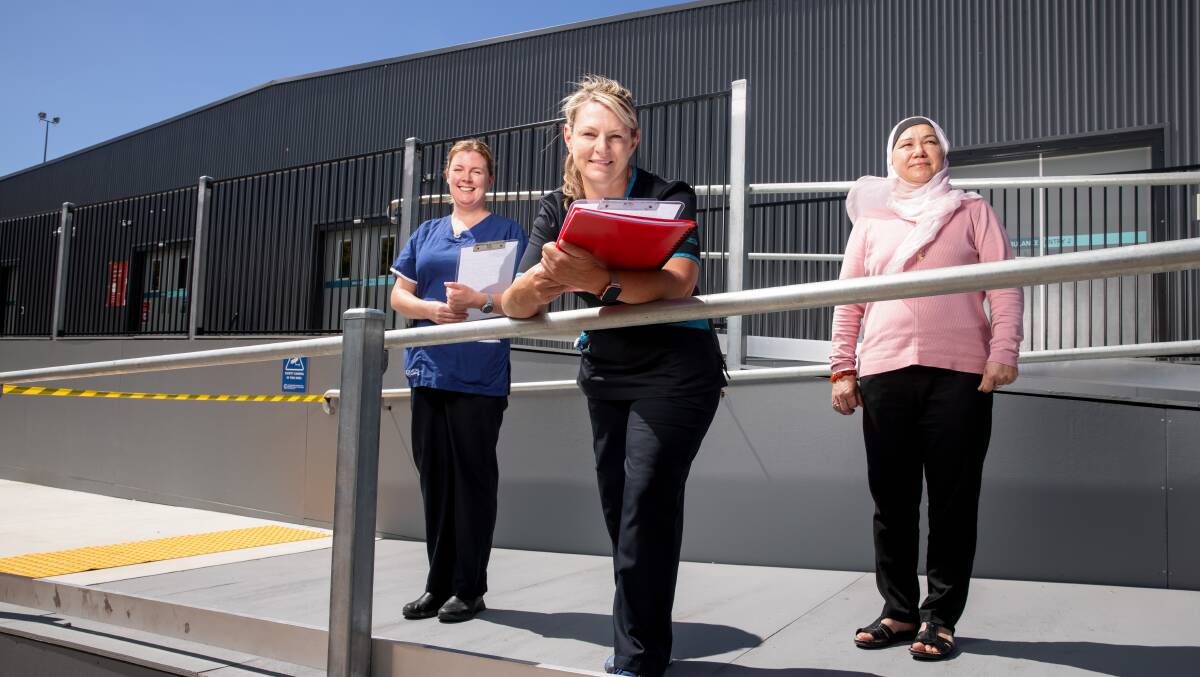 Staff at the COVID-19 vaccine rollout at the Garran COVID-19 surge centre include Kimberley Phelan, Cimone Gray, and Bibi Kazmi. Picture: Sitthixay Ditthavong.