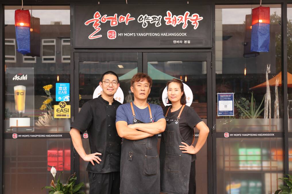 Man Young Park, owner of Mr Mom's Yangpyeong Haejanggook restaurant in Dickson, centre, with Junwoo, left, and Myunjin. Picture: James Croucher