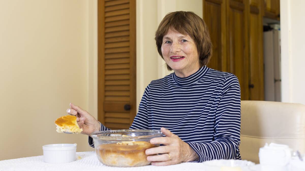 Maureen Davenport serving her apple sponge pudding. Picture: Keegan Carroll