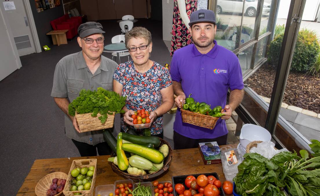 Volunteers Joe, Julie and Samuel Fenech selling the fresh produce grown by Canberra City Care. Picture: Keegan Carroll