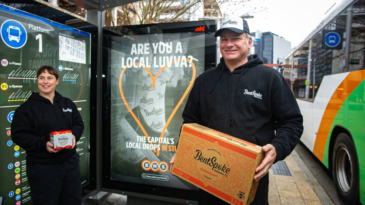 Tracy Magrain and Richard Watkins are starring on a big billboard with BWS promoting local brewers. Picture: Elesa Kurtz