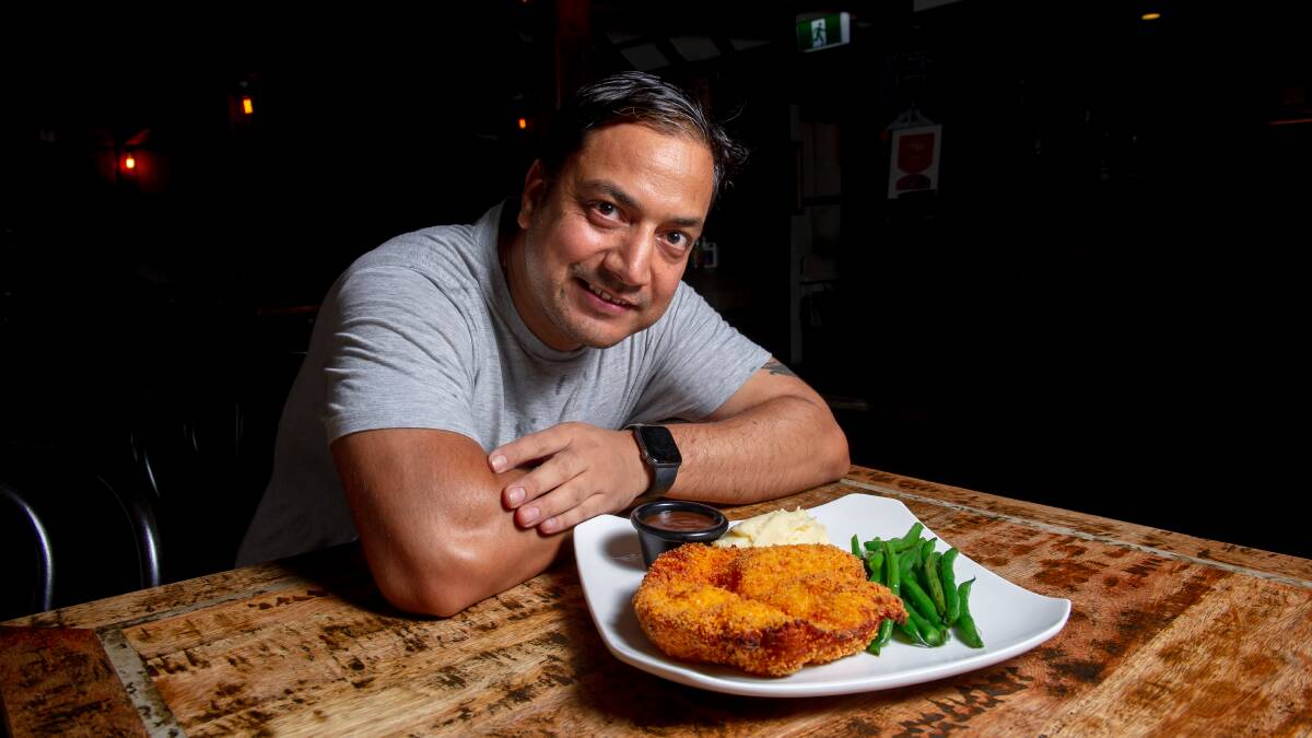 Chef Sudhan Gautam with the feast from the Old Canberra Inn. Picture by Elesa Kurtz