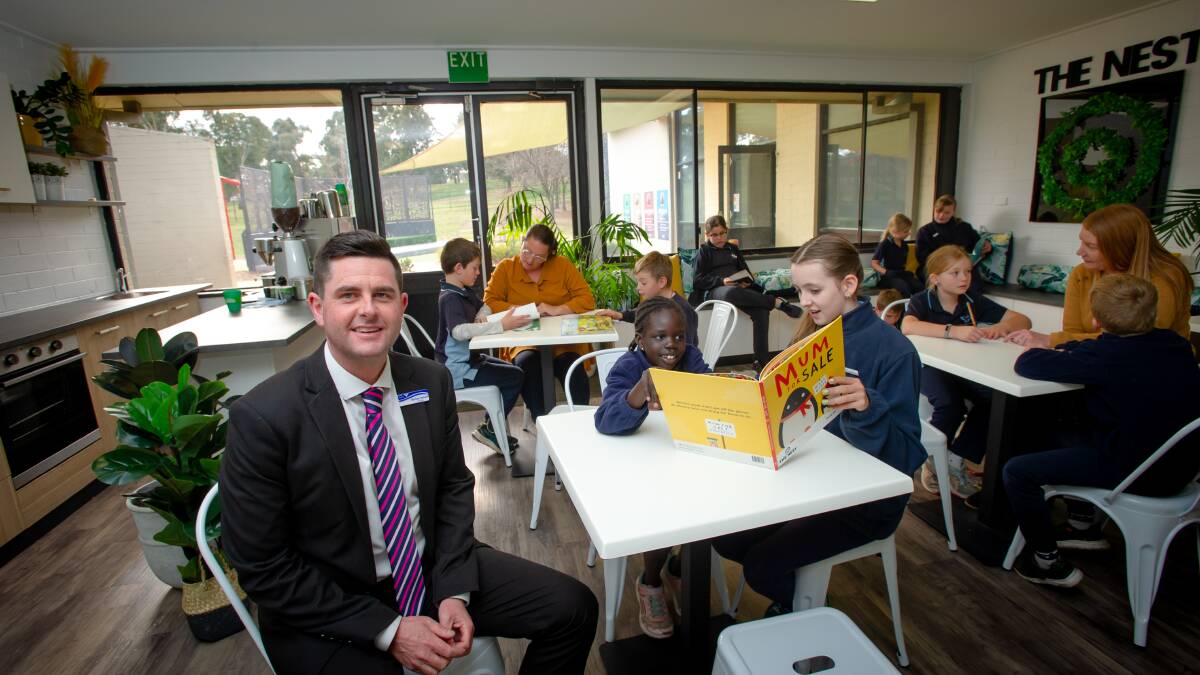 Evatt Primary School principal Michael Hatswell with students, parents and teachers in the new The Nest cafe. Picture: Elesa Kurtz