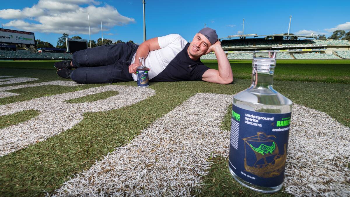 Former Canberra Raiders player Terry Campese with the Underground Spirits gin distilled to commemorate the club's 40th anniversary. Picture by Sitthixay Ditthavong 