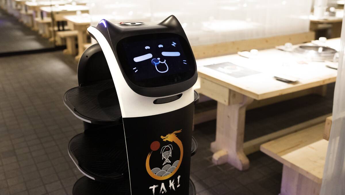 Taki's smiling robot waiter is a fun addition to the experience. Picture by Sitthixay Ditthavong