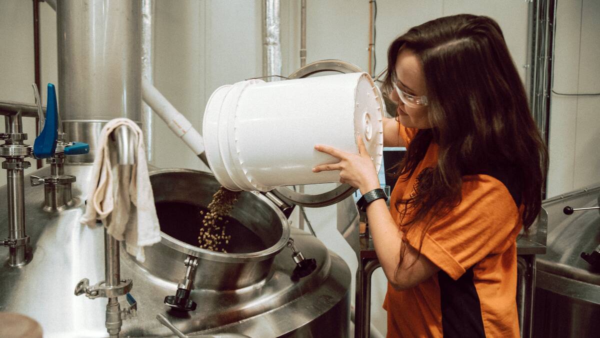 Sherri Dill adds the proprietary hops to the kettle. Picture: Supplied