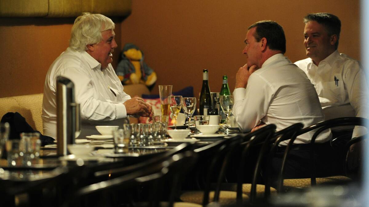 Clive Palmer, Christopher Pyne and Mathias Cormann get down to business or is it dumplings, at China Plate in 2015. Picture by Melissa Adams