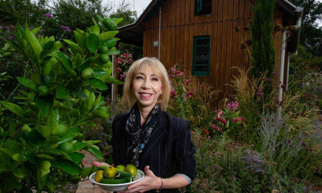 Kitchen gardener Pip Thompson with a harvest of zucchinis and tomatoes. Picture: Elesa Kurtz