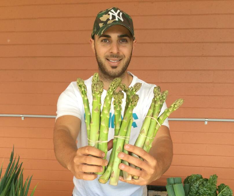 Frank Verduci Jr. at Southside Farmers Market with asparagus grown on his family farm. Picture: Susan Parsons