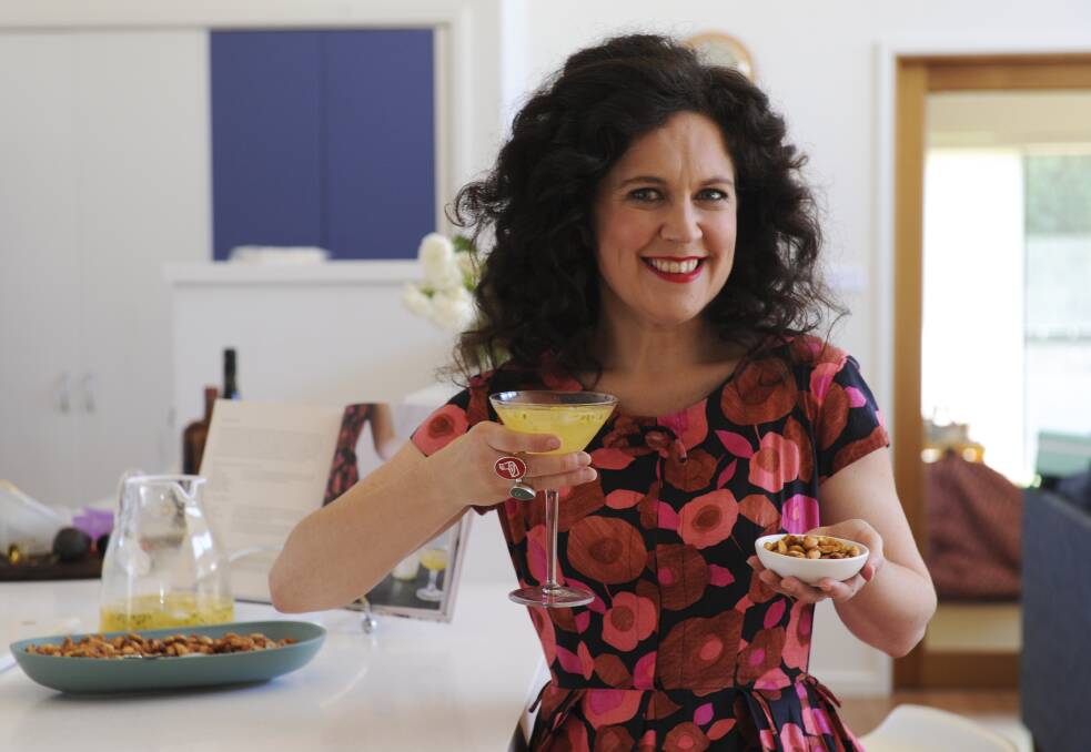 Annabel Crabb enjoys a cocktail and some nuts at the home of Karen Hardy. Little did she know. Picture: Graham Tidy