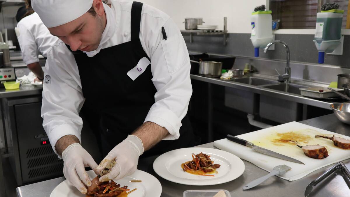Noah Cairnduff prepares his winning dish at the Golden Chef Awards. Picture: Supplied