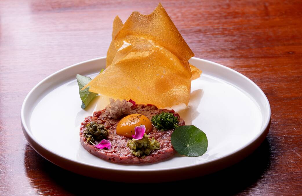Tartare de boeuf. Traditional steak tartare, cured egg yolk, smoked potato tuille. Picture: Sitthixay Ditthavong