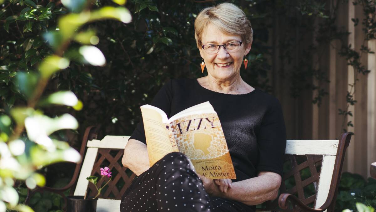 Canberra writer Moira McAlister with her first book, Izzy, based on an ancestor's life, at her home in Downer. Picture: Dion Georgopoulos 