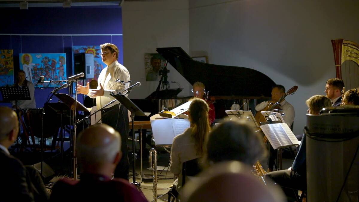 Vietnam Requiem's director and musical director Chris Latham rehearses with the orchestra. Picture: Craig Alexander