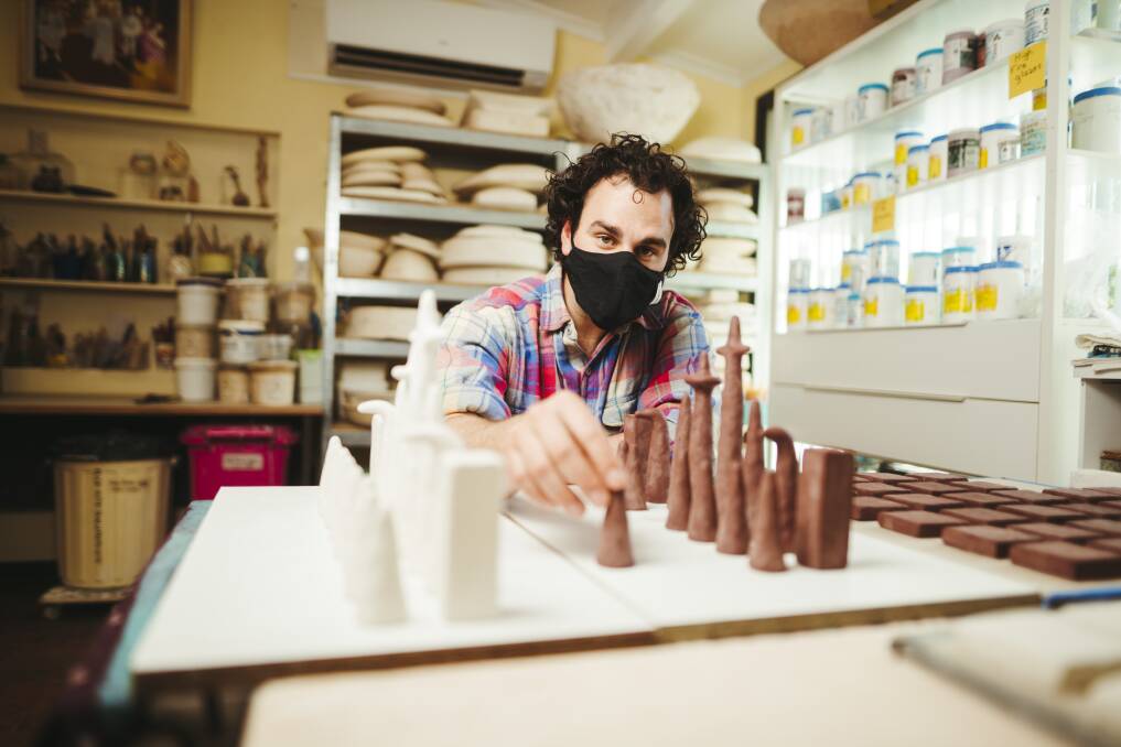 Artist Daniel Leone, creator of dL Designs, works on a ceramic chess set at his home in Mawson. Picture: Dion Georgopoulos 