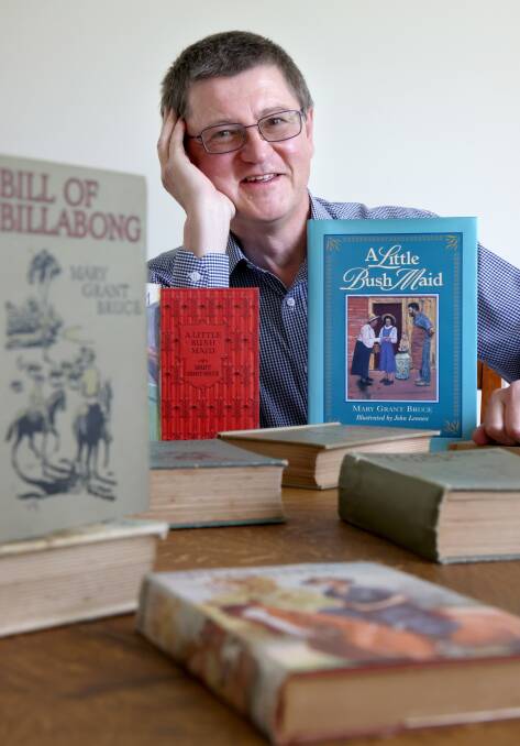 Ian Bruce at his home in Dickson with some of his grandmother Mary Grant Bruce's books. Picture by James Croucher