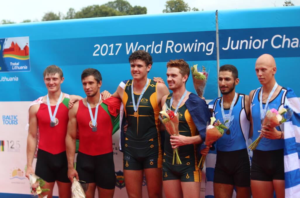 Fergus Hamilton on the podium with Cormac Kennedy-Leverett (centre) after the pair won the junior men's doubles world title in Lithuania in 2017. Picture supplied
