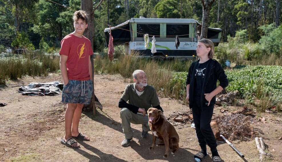 Edward Whiteside with his sons Jasper, 14, and Sheamus, 13, at their campsite at Weetah, where they have lived in a campervan and tents for four years. Picture: Phillip Biggs