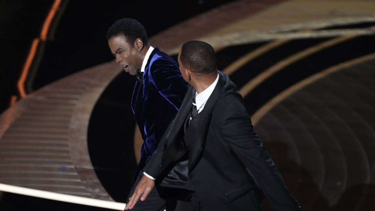 Will Smith confronts Chris Rock as he presents the award for best documentary feature. Photo: Robert Hanashiro-USA TODAY/Sipa USA /AAP Image