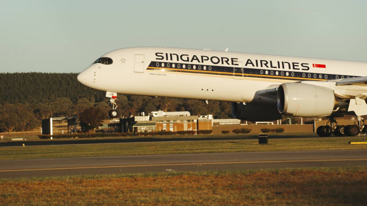 The Singapore Airlines flight touches down at Canberra Airport on Monday. Picture: Dion Georgopoulos
