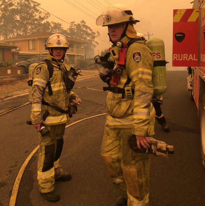 Greg Mullins (left) and a fellow RFS volunteer in action during this summer's bushfires at Batemans Bay. Picture: Greg Mullins 