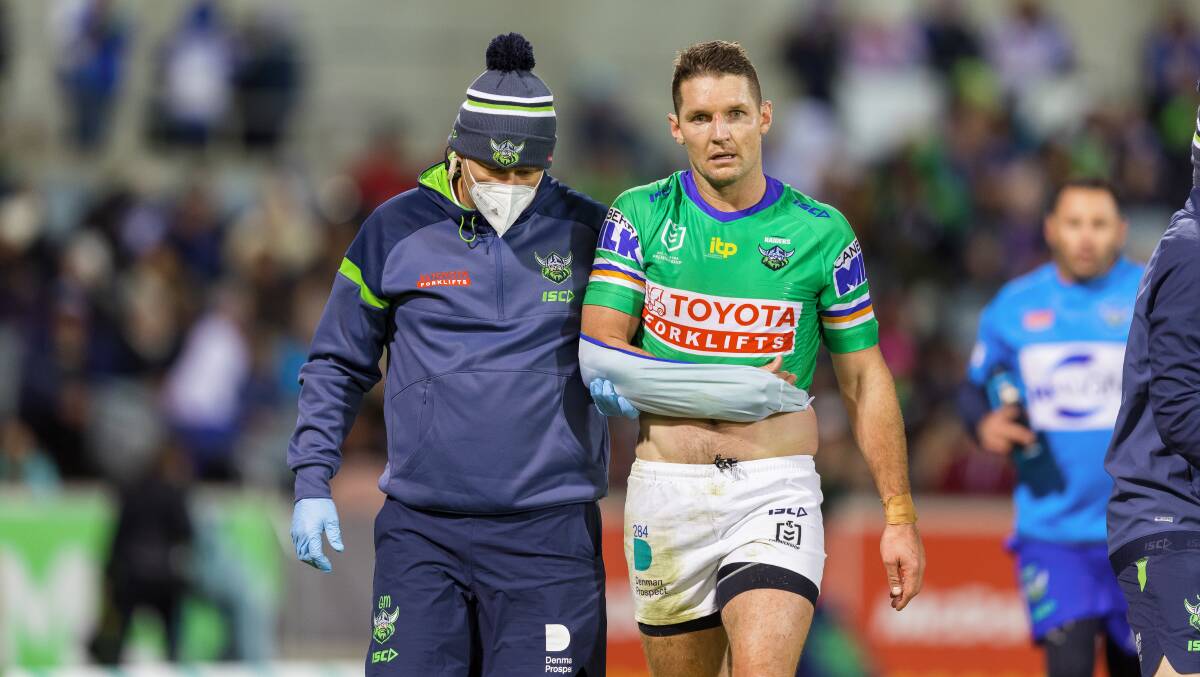 Jarrod Croker is assisted from the field after his late injury. Picture: Sitthixay Ditthavong