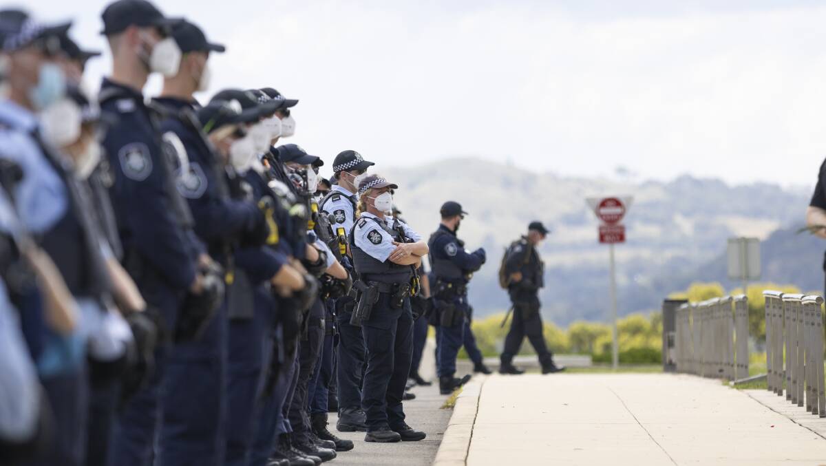 Police officers form a line outside Parliament House. Picture: Keegan Carroll