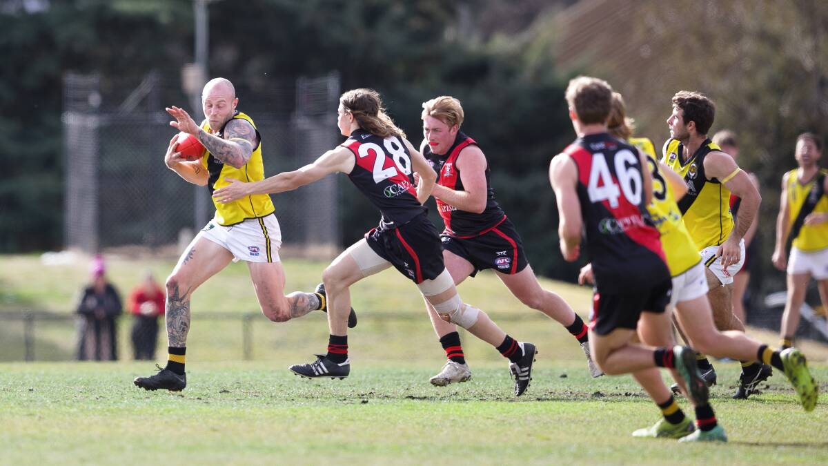 Lachlan Highfield looks to escape the clutches of Eastlake's defence. Picture: Sitthixay Ditthavong
