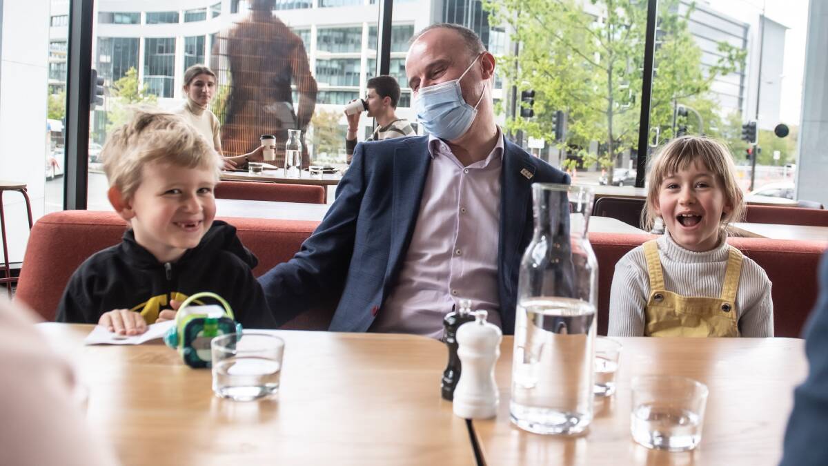 Chief Minister Andrew Barr celebrates the end of lockdown with his nephew Gus and niece Zoe at a Civic cafe yesterday. Picture: Karleen Minney