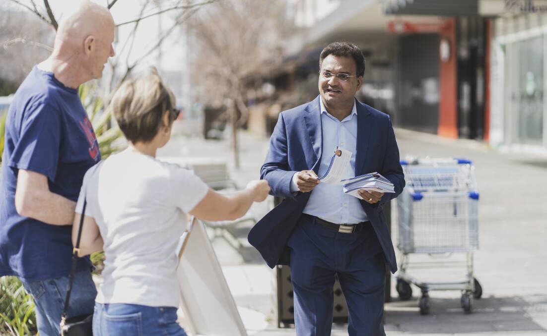 Liberals candidate Jacob Vadakkedathu talks to voters in Gungahlin. Picture: Dion Georgopoulos