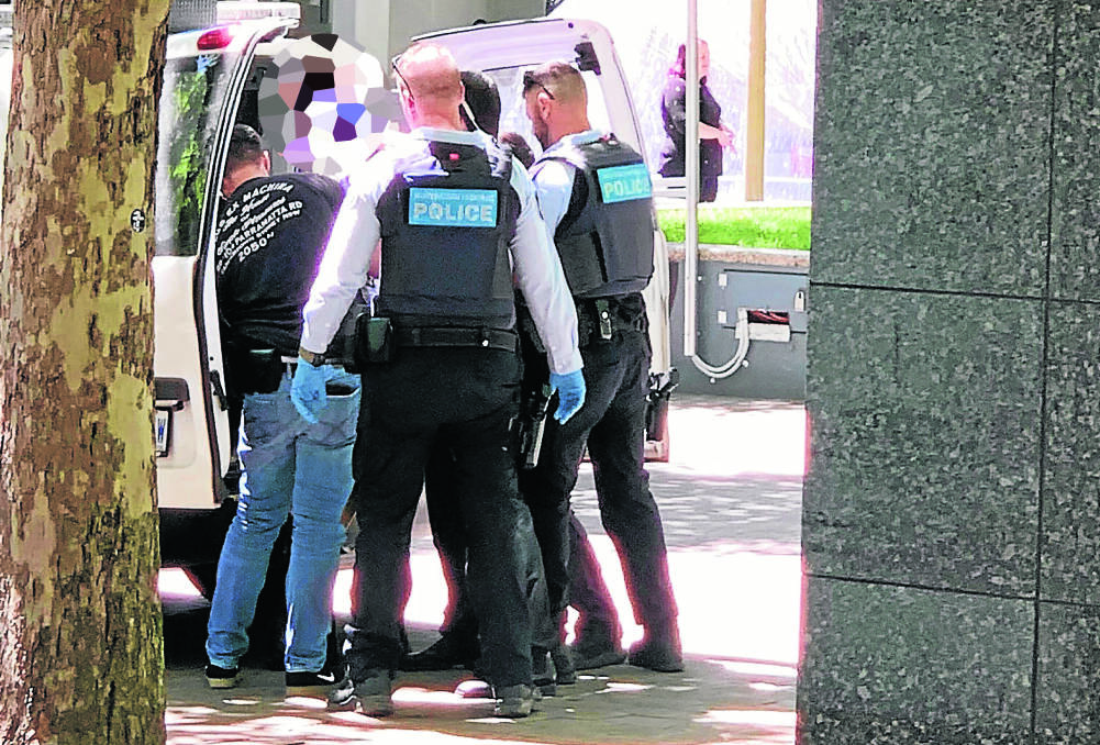 Police arrest a man shortly after the incident. Picture: Jason Moffett