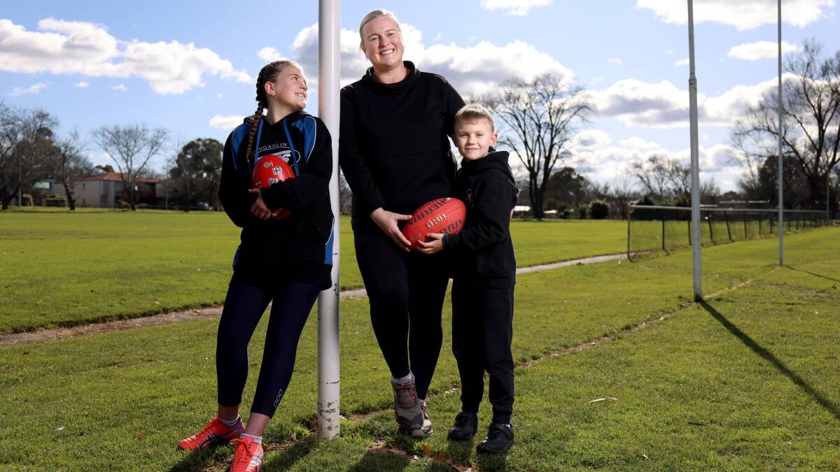 Rebecca Hurrell at Ainslie Oval with niece Elise Burrell, 12, who plays for Gungahlin, and son George, 6, who plays for Belconnen. Picture: James Croucher