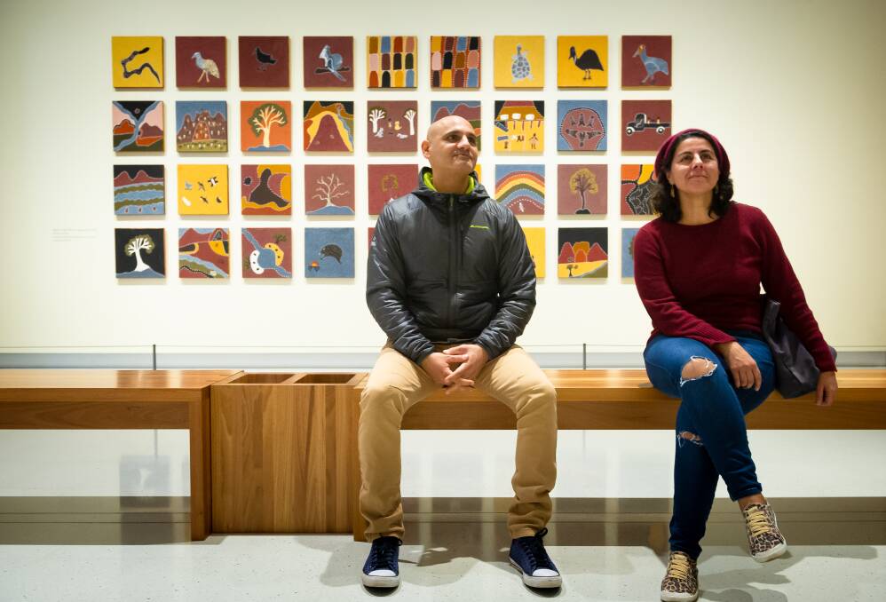 Ron Saleh and Daniela Cristallo view Shirley Purdie's Ngalim-Ngalimbooroo, 2018, at the National Portrait Gallery on Saturday. Picture: Elesa Kurtz