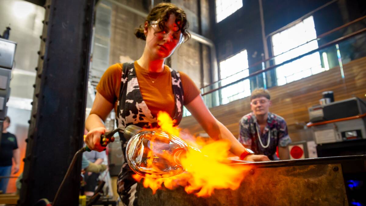 Dylan McCracken heats glass to the extreme temperatures required to mould it into art at Canberra Glassworks. Picture by Elesa Kurtz