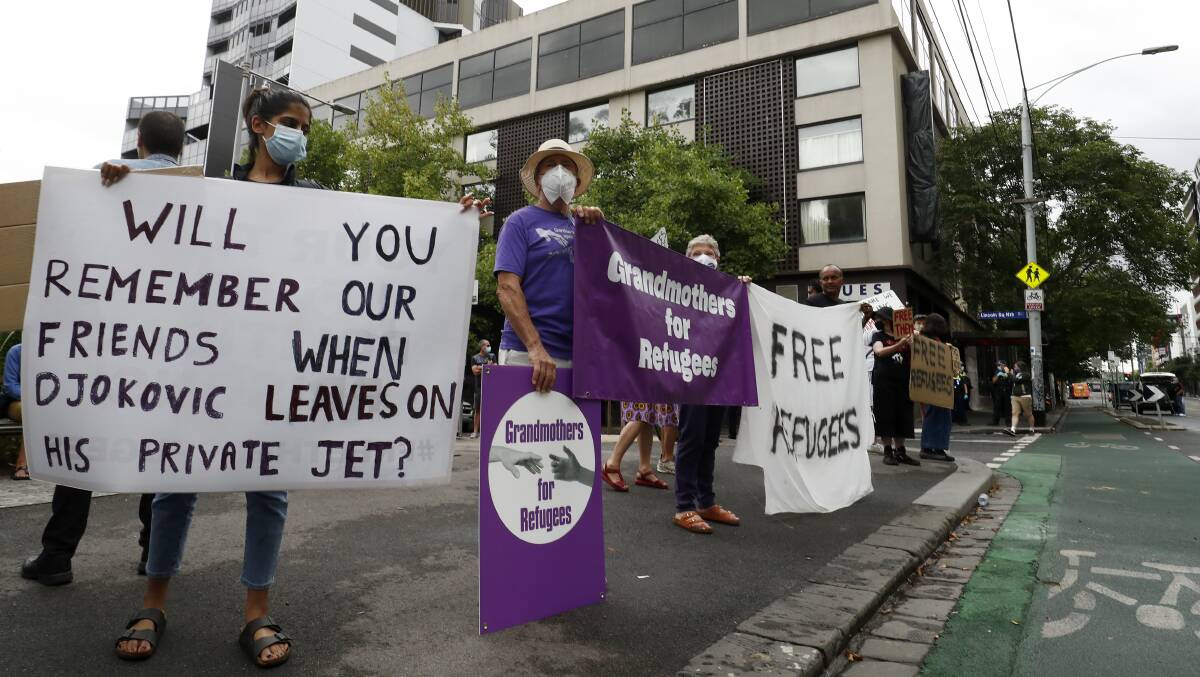 Protesters highlight the plight of refugees detained in the same Melbourne hotel as tennis star Novak Djokovic last week. Picture: Getty Images