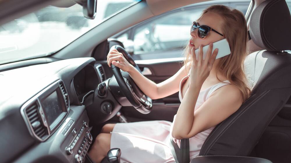 Canberrans caught on camera using their phones while driving have earned a reprieve - for now. Picture Shutterstock 