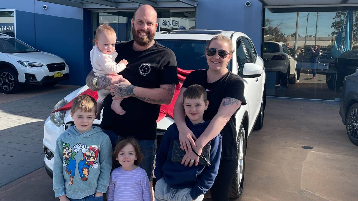 William Johns, 7, with his stepdad Scott Phillips, mum Alisha Konig and siblings Christopher, 9, Charlie, 4, and Addeline, 11 months, with the new car. Picture: Supplied