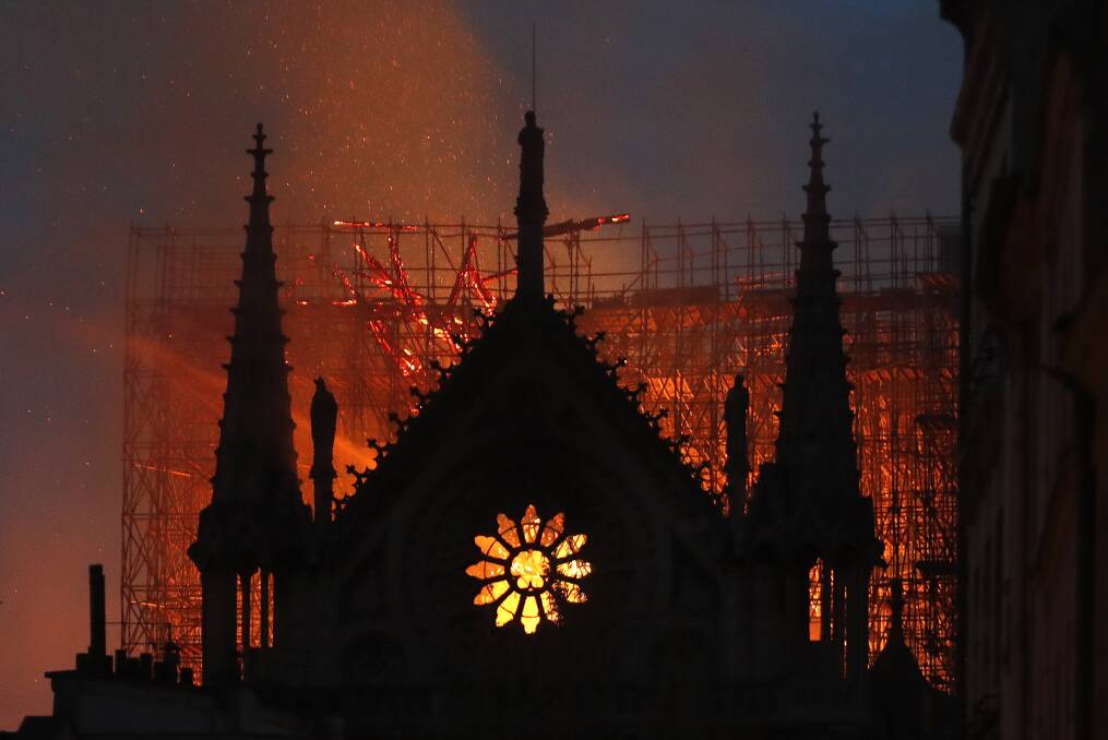 Flames and smoke rise from Notre Dame cathedral as it burns in Paris. Photo: AP. 
