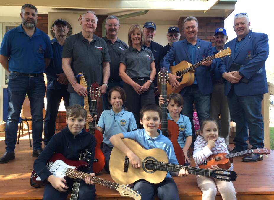 
GREAT DAY: ACT-based Soldier On Music Group members Col Greef and Mike Hogan and Soldier On programs officer Debbie Dimmock with members of the Keith Payne VC Veterans Benefit Group and Bomaderry Public students Dustin Peters, Charlotte Whittaker, Logan Peters, Sam Whittaker and Alexis Peters and their new guitars.
