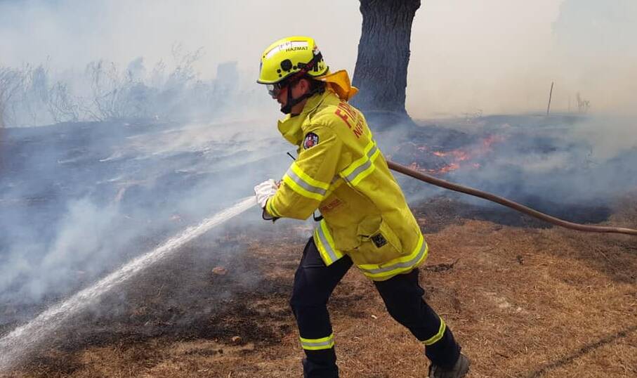 Fire and Rescue NSW Station 405 Nowra member fighting the fires.
