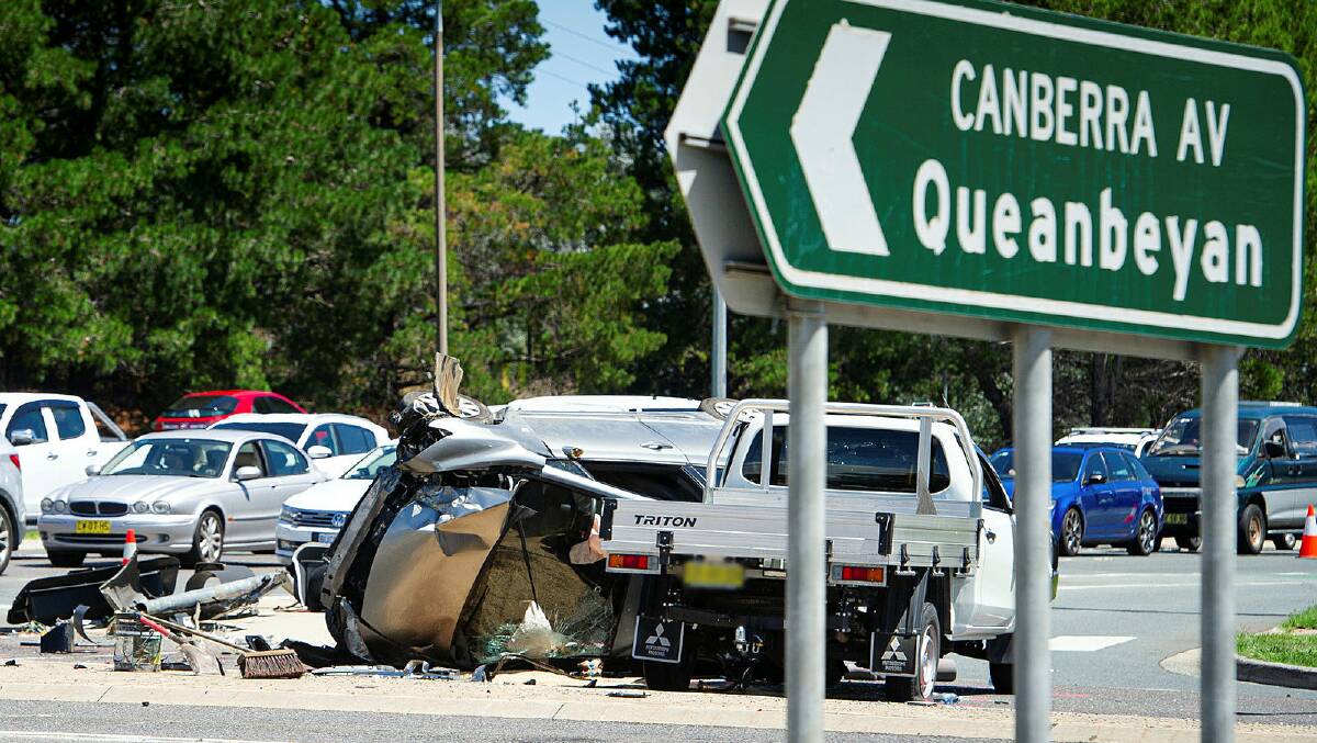A car flipped on its side at the intersection of Canberra Avenue and Newcastle Street, Fyshwick on Saturday morning. Picture: Elesa Kurtz