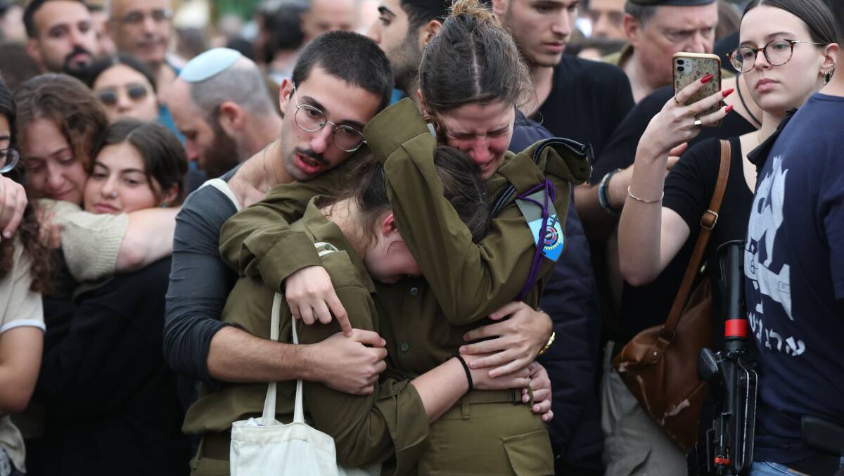 Israeli soliders mourn during the funeral of soldier Lavi Lipshitz in Jerusalem, who was killed during a battle against Hamas militants on October 31, the Israel Defence Forces said.
